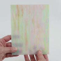 Video of the witched glass plate in beige translucent iridescent, 15x19cm, held up and tilted to show its pattern and transparency