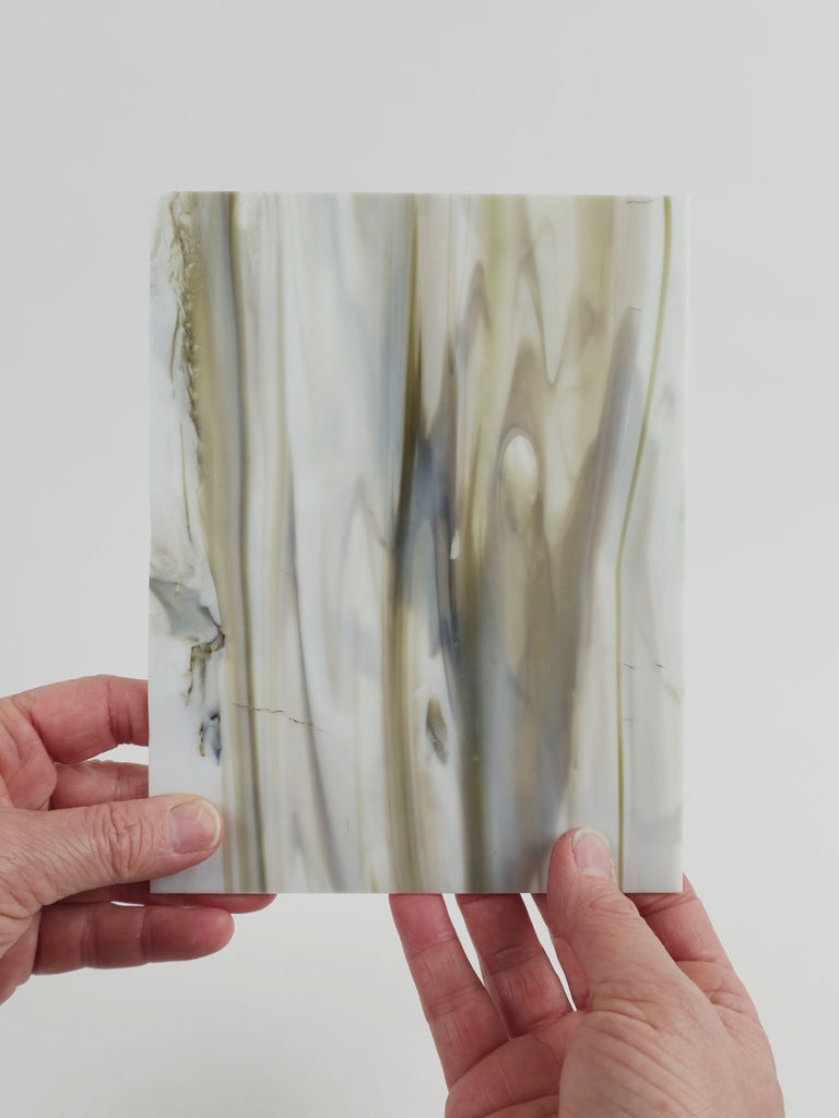 Video of the marbled grey glass plate in grey marbled translucent, 15x19cm, held up and tilted to show its pattern and transparency
