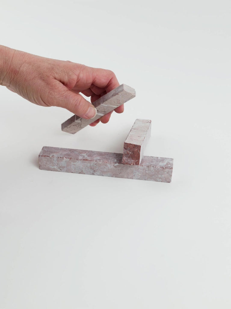 Video of Marble Bars XL Rose in opaque pink natural marble, 1–20 cm long and 8 mm thick, picked up by hand and turned to show their length, colour and natural veining