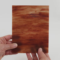 Video of the Sunset glass plate in translucent pink, 15x19cm, held up and tilted to show its pattern and transparency